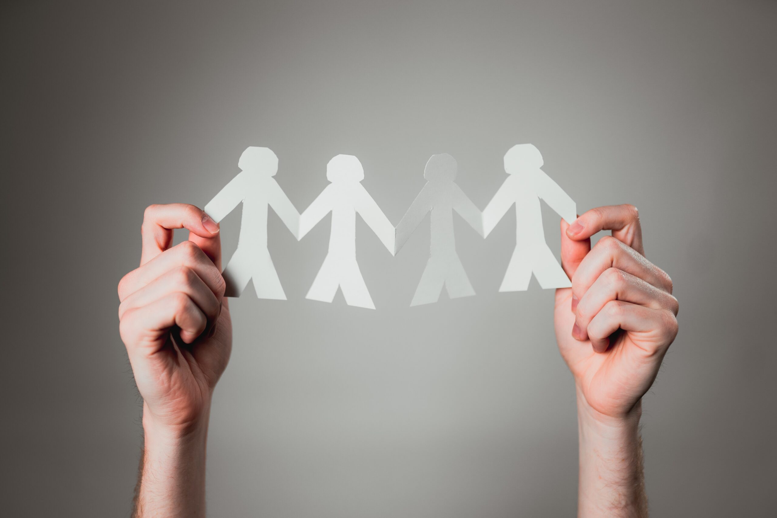 andrew-moca-yAGNjU4rtss-unsplash man carrying baby close-up photography